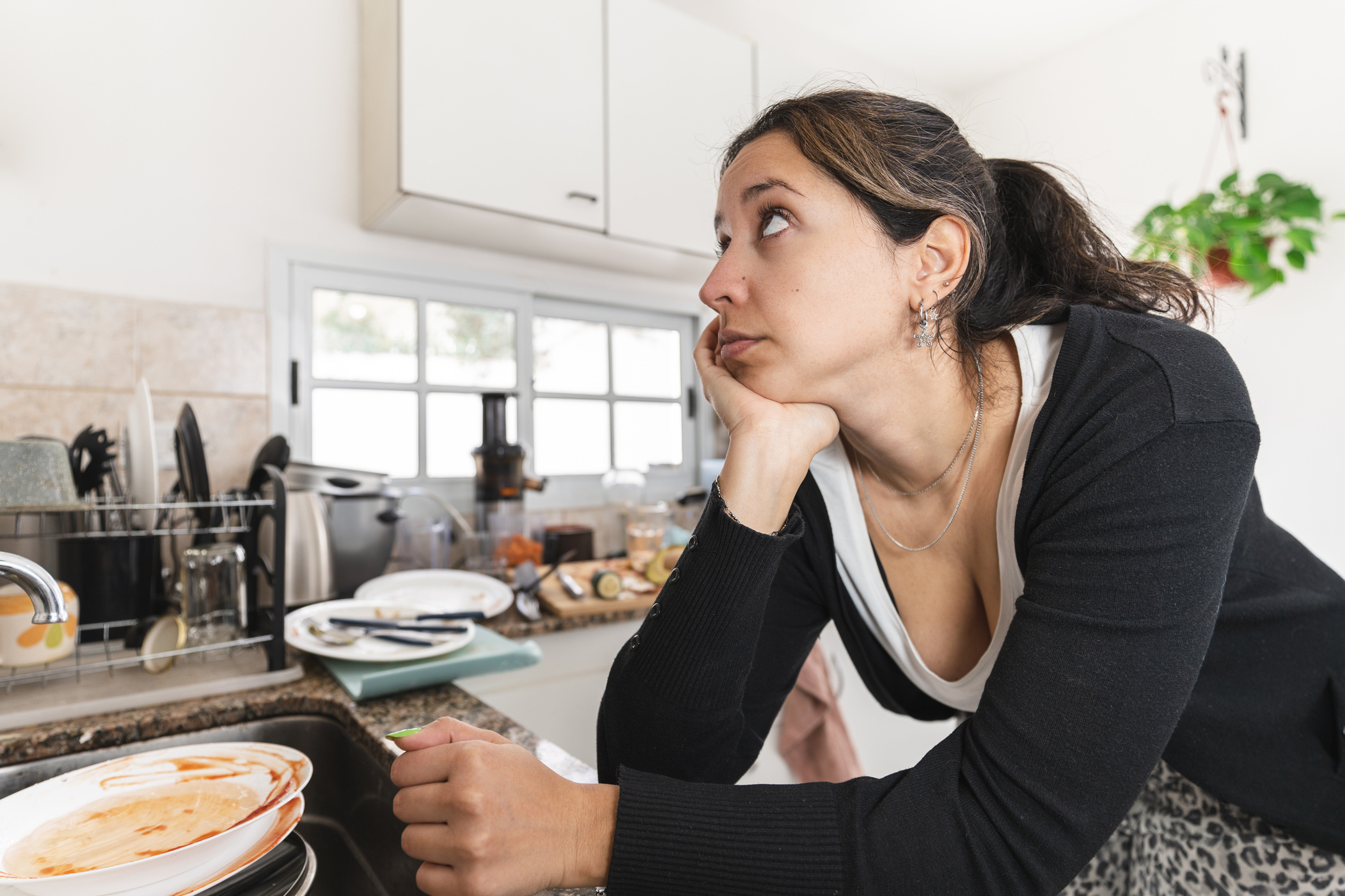Latin woman worried about her messy kitchen